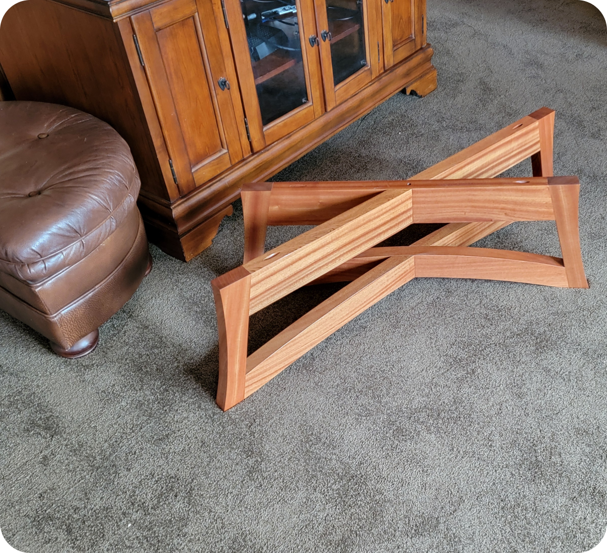 Wooden stand on carpeted floor, near furniture.
