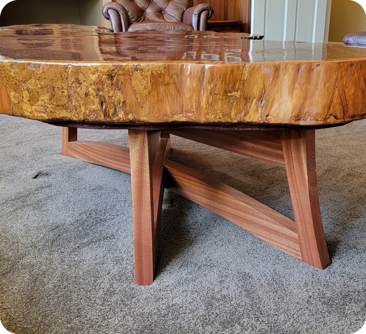 Wooden table with intricate base design.