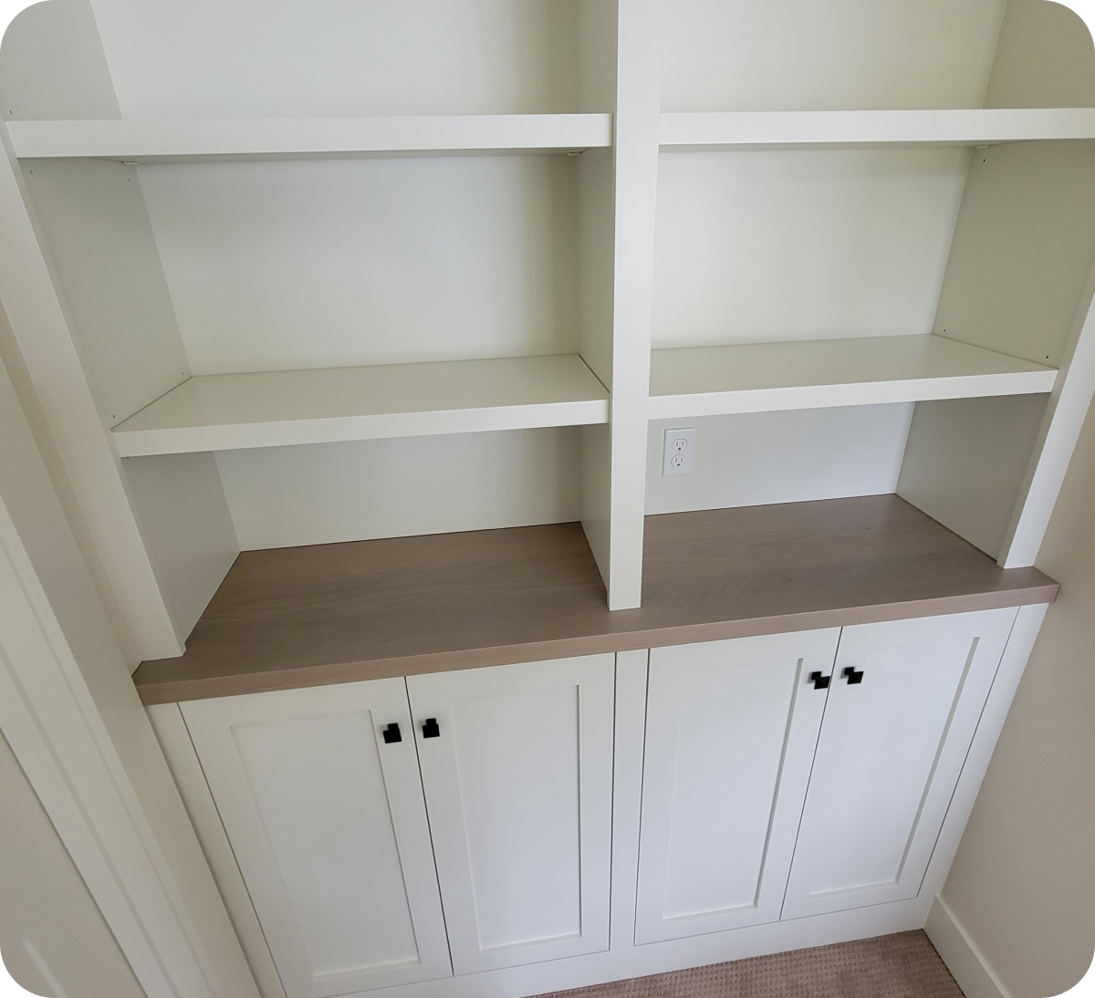 White built-in shelves with cabinet below.