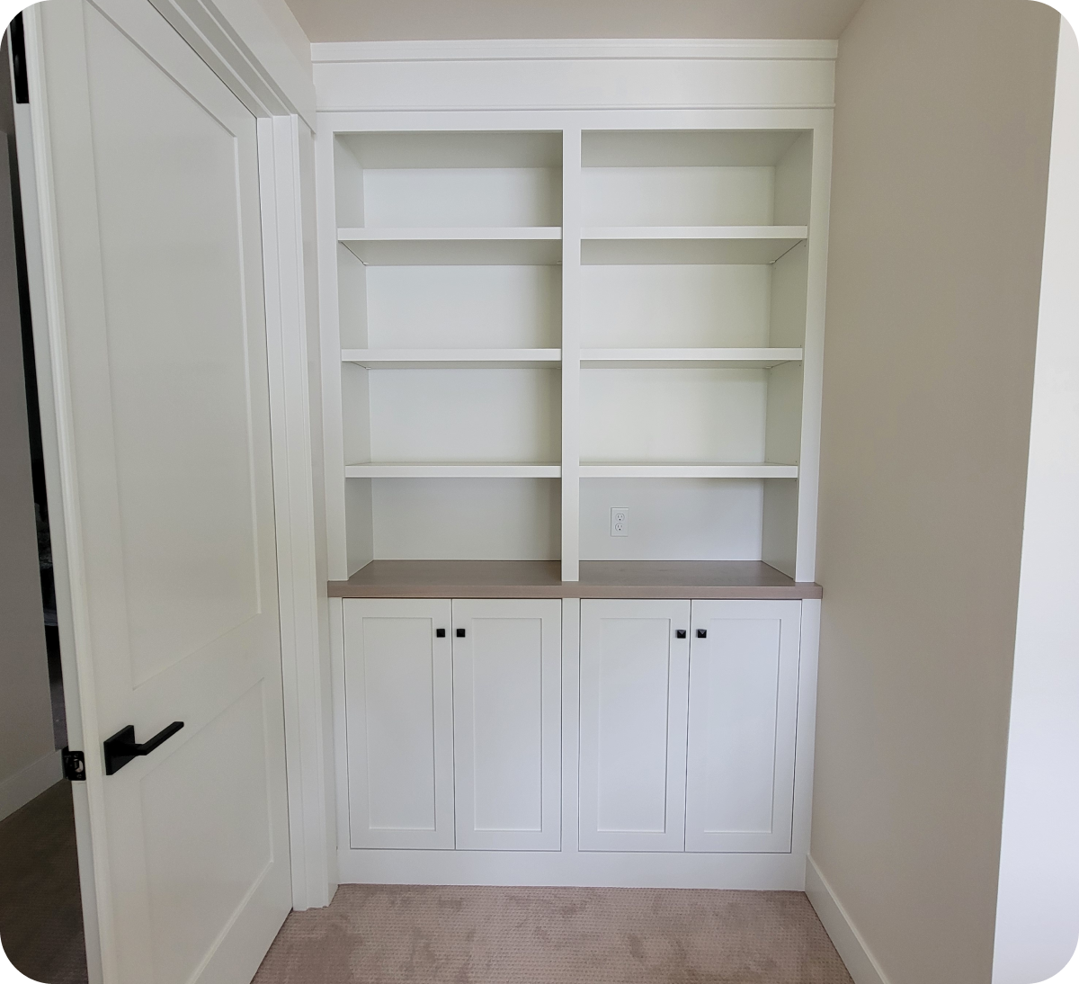 White built-in shelves with closed cabinets.